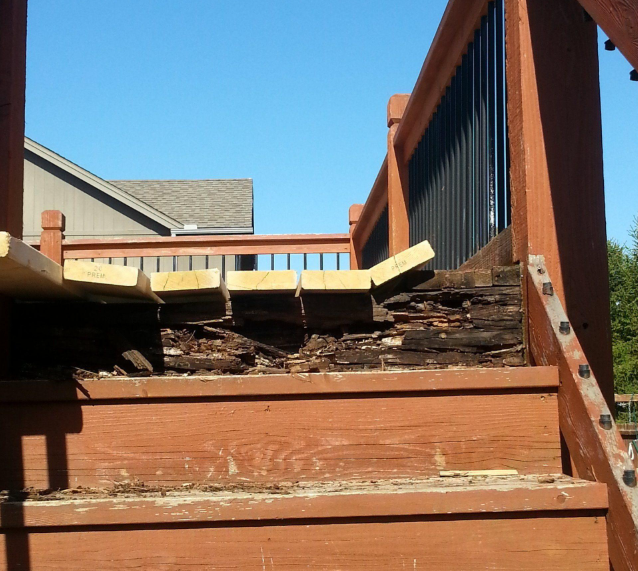 Damaged deck boards and framing shown before repairs during Deck Building Services in Buckeye, AZ for safer outdoor use.
