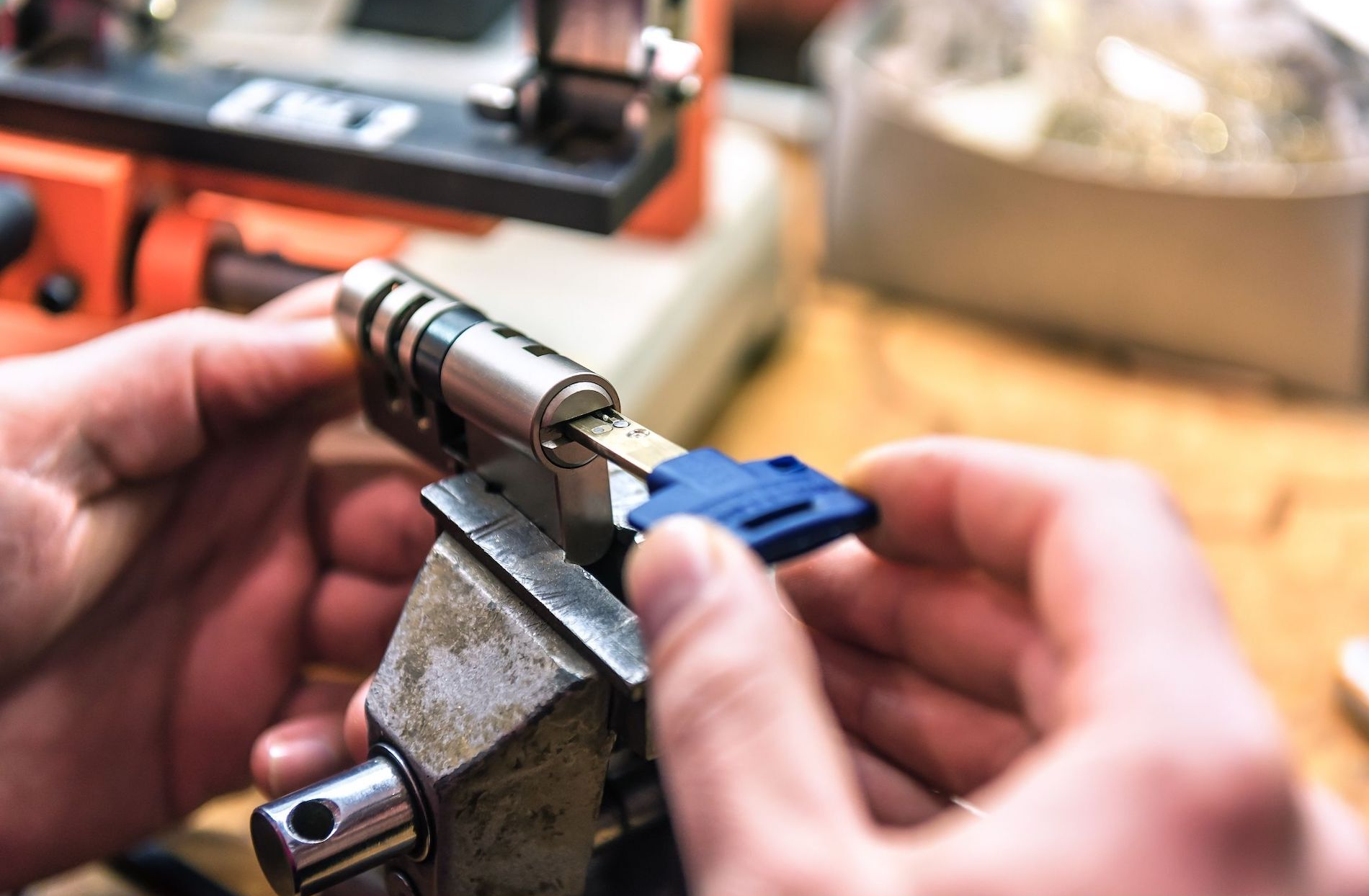 locksmith holding key and lock exposed