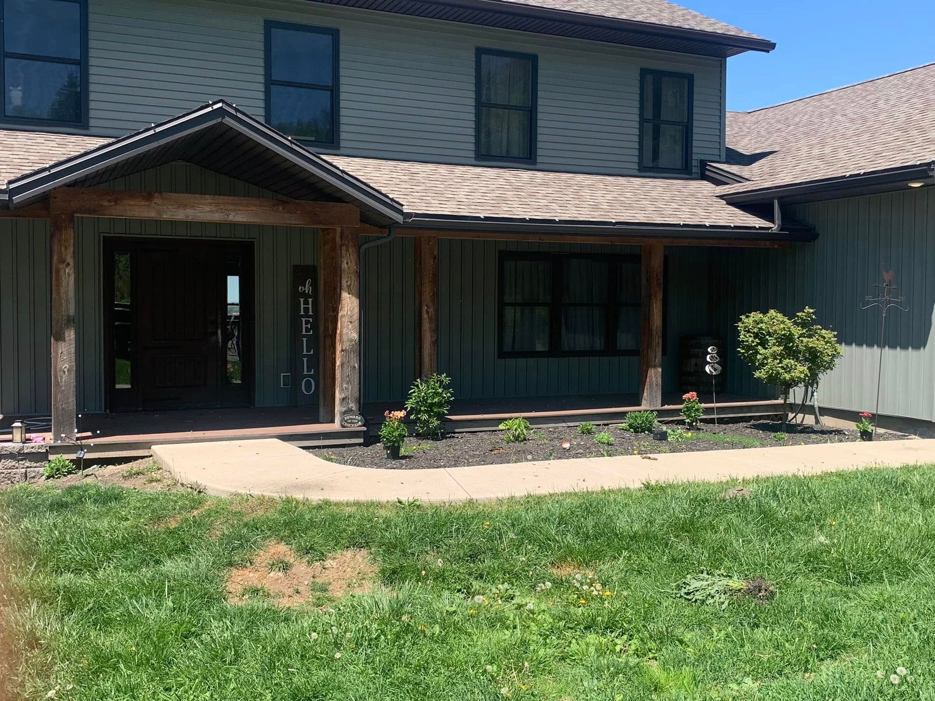 A large house with a porch and a walkway in front of it.