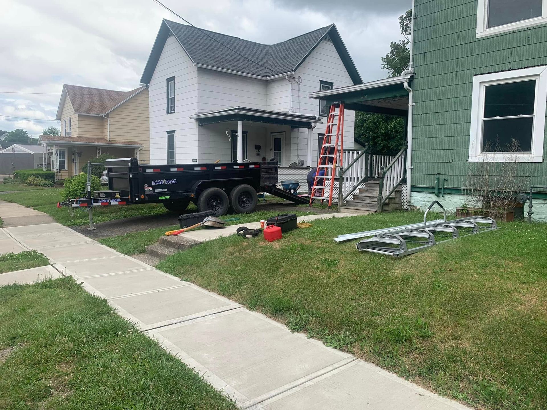 A dump truck is parked in front of a house.
