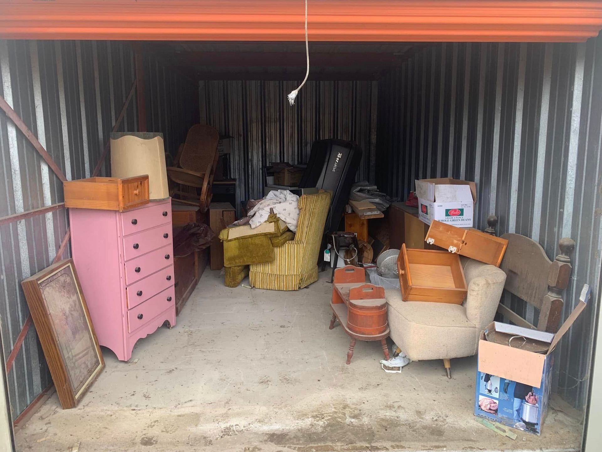 A garage filled with lots of furniture and boxes.