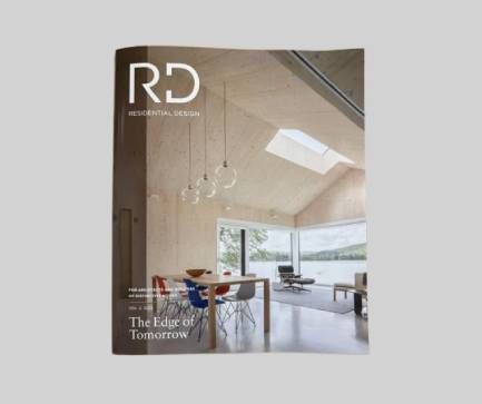 Magazine cover showing a modern bright interior with large windows, pendant lights, and dining furniture