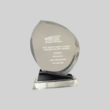 Glass award plaque on a clear base with engraved text and a gold “Award” designation