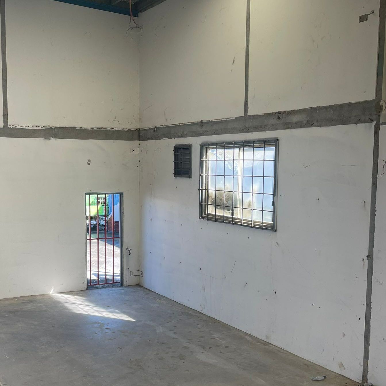 An Empty Room With White Walls and a Window — Demco In Currumbin Waters, QLD