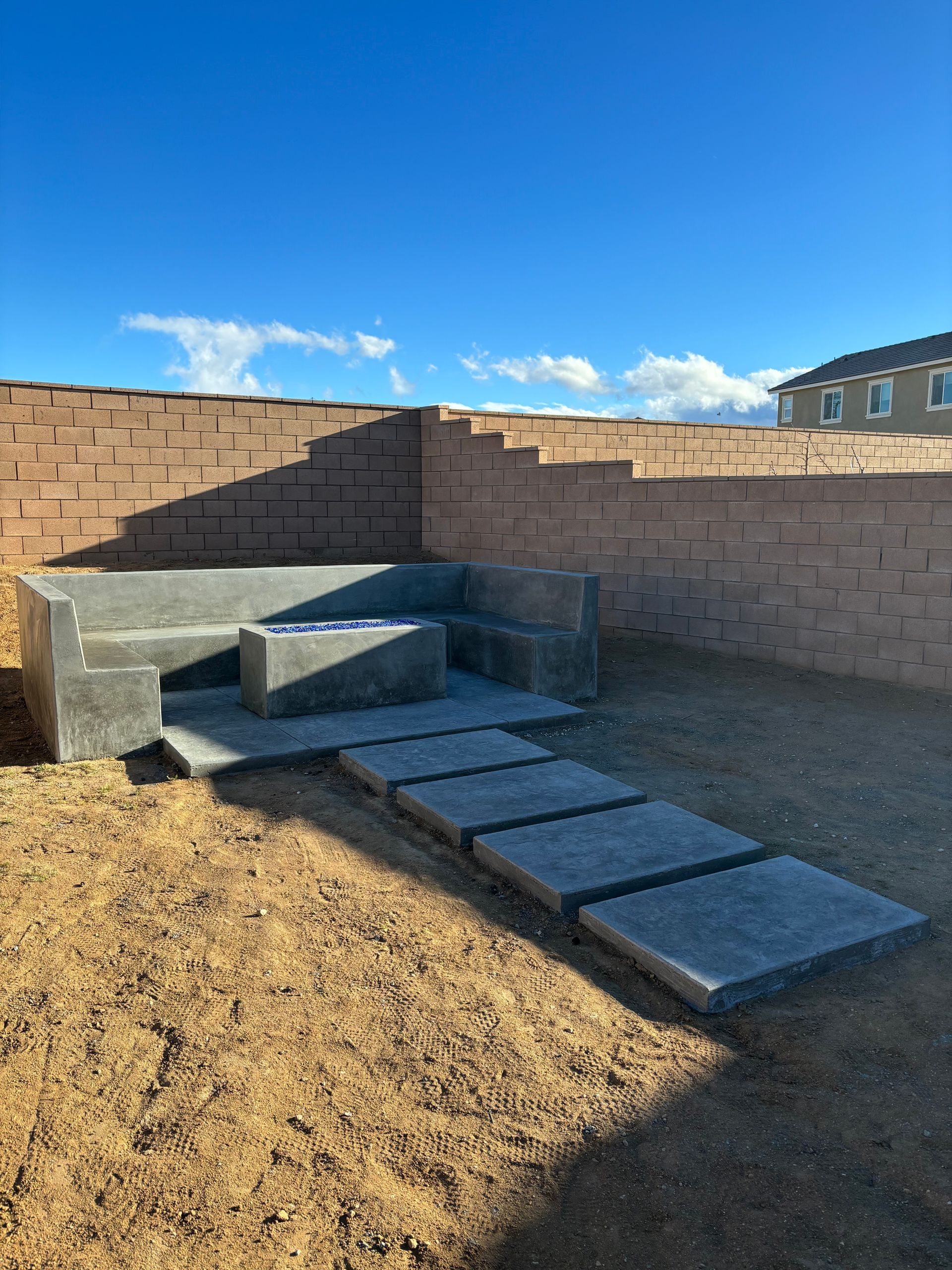Smooth concrete bench and broom finish stepping stones in Victorville California