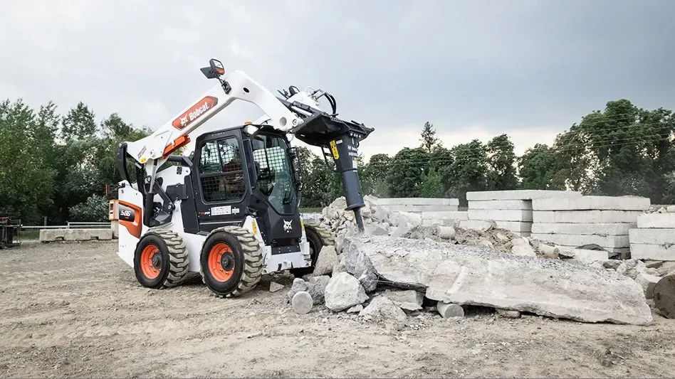 Bobcat breaking concrete slab for demolition in Ontario California