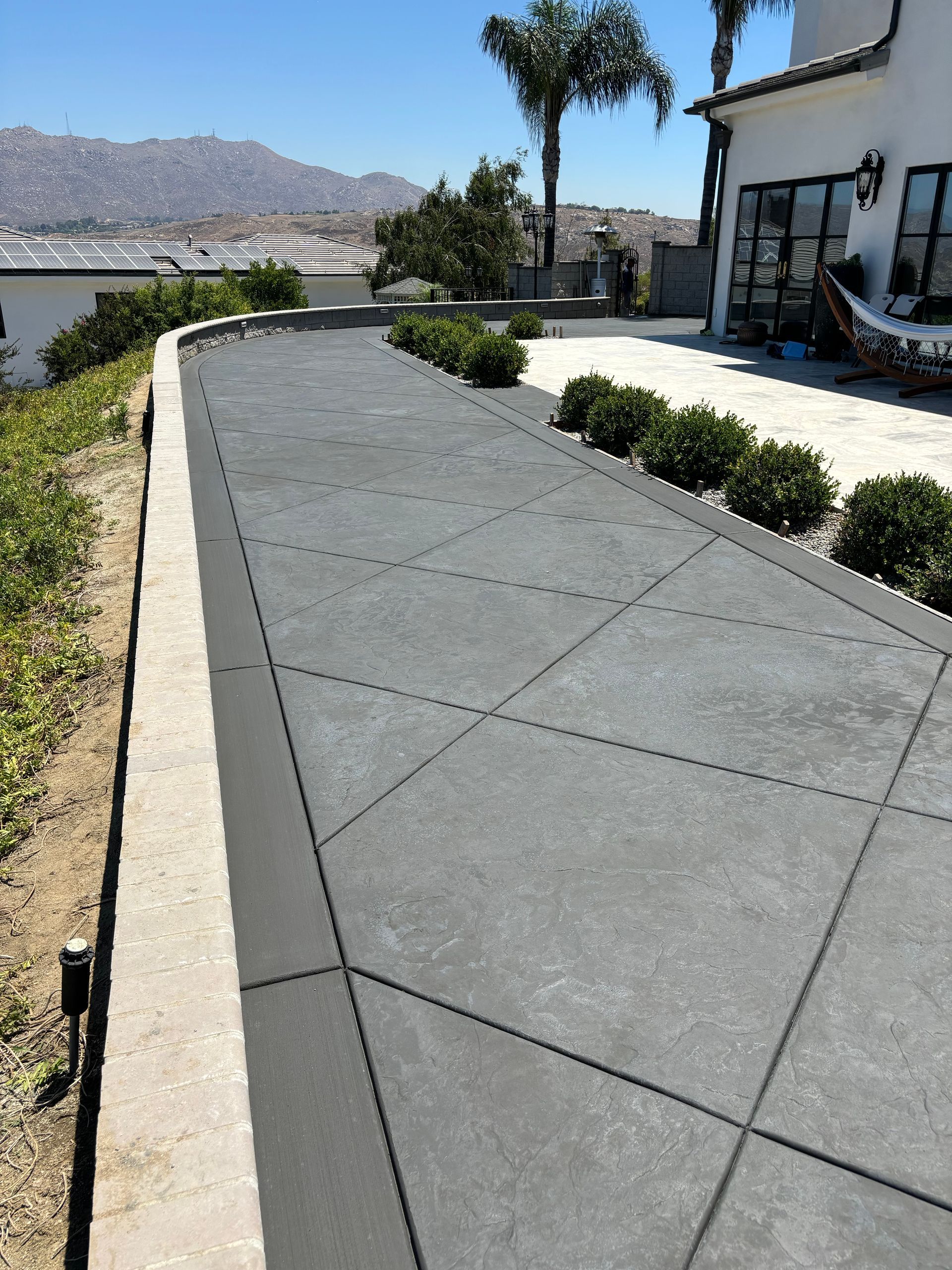 Roman slate stamped concrete with broom finish border in Riverside California