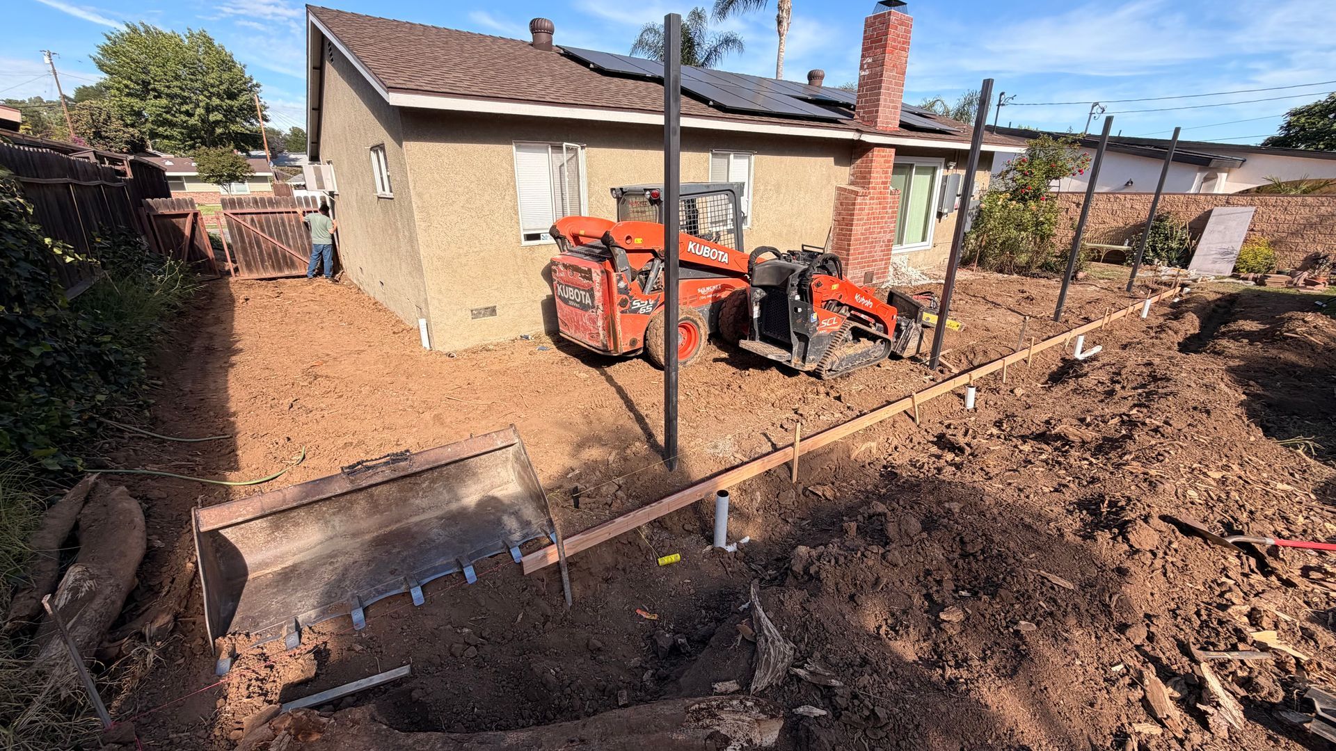 Skid steer grading backyard for new concrete patio Chino Hills