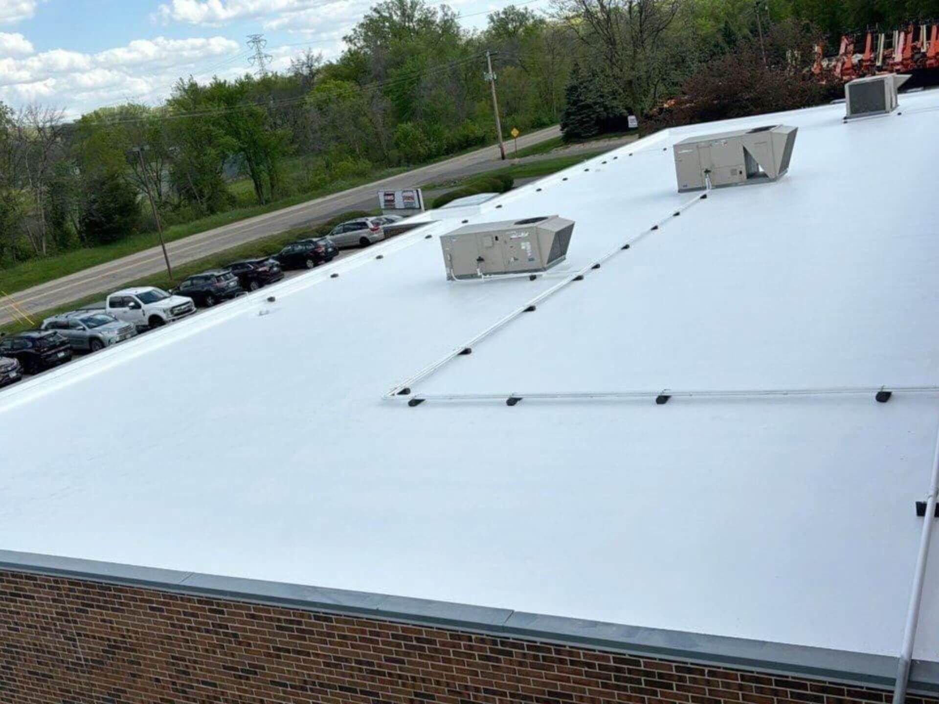 Commercial membrane roof coating around a rooftop pipe in Hudson, WI