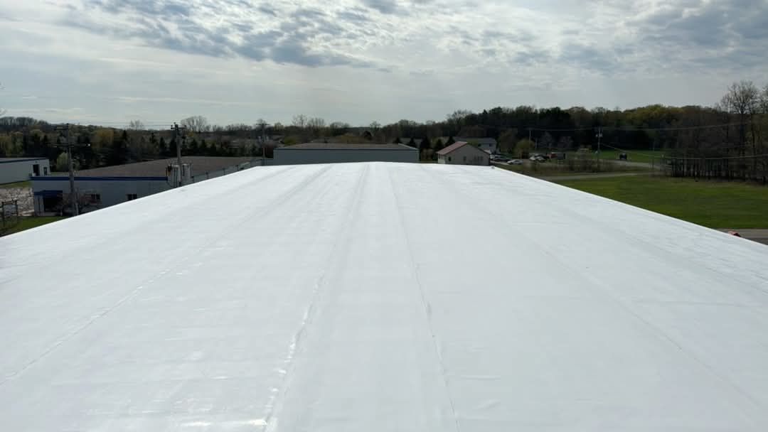 A large white roof with a lot of snow on it.
