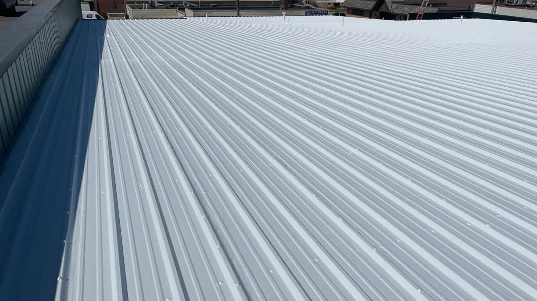 A large white roof with a blue sky in the background.
