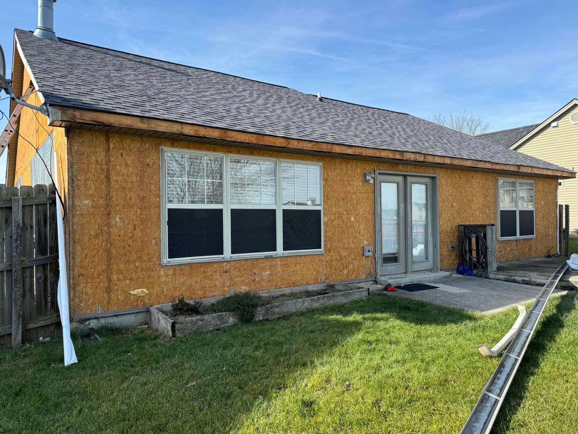 A house with a roof and a lot of windows is being built.