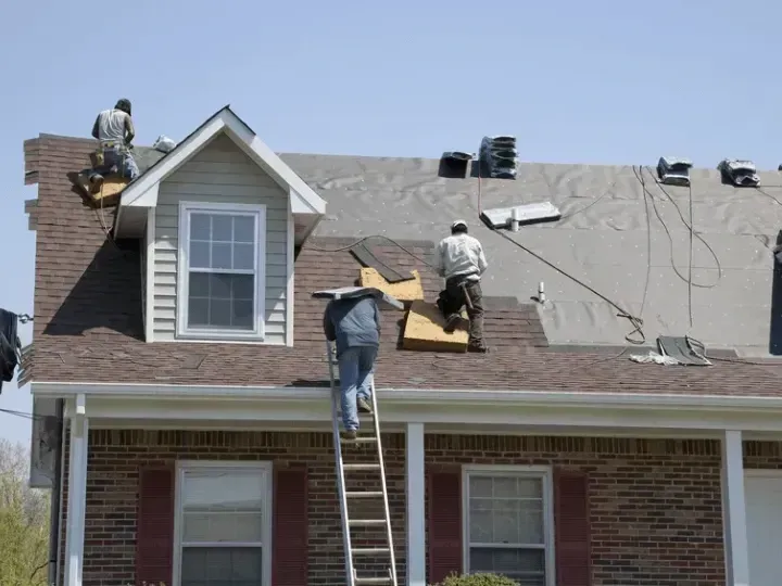Ark roofer drilling roof wall for roof replacement from storm damage in Lexington, Kentucky