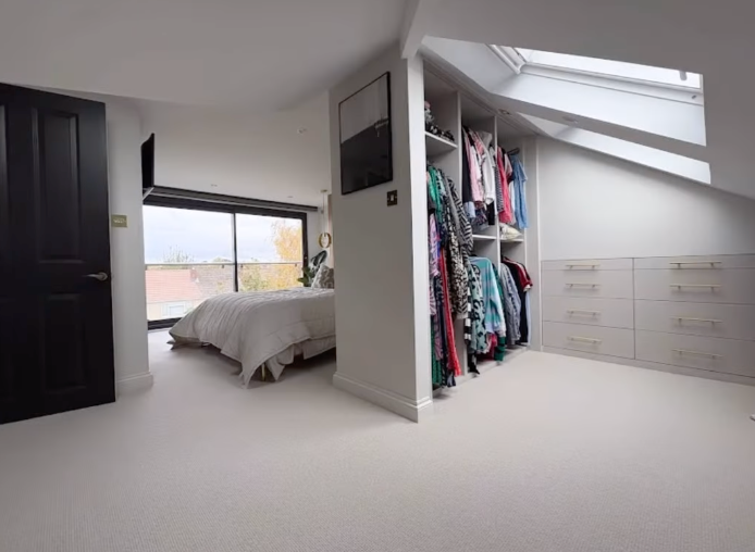 Loft conversion bedroom and loft clothing area.