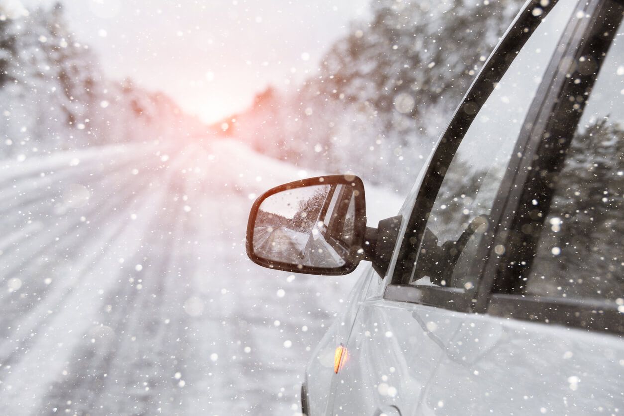 A car is driving down a snowy road. | The Euro Shop