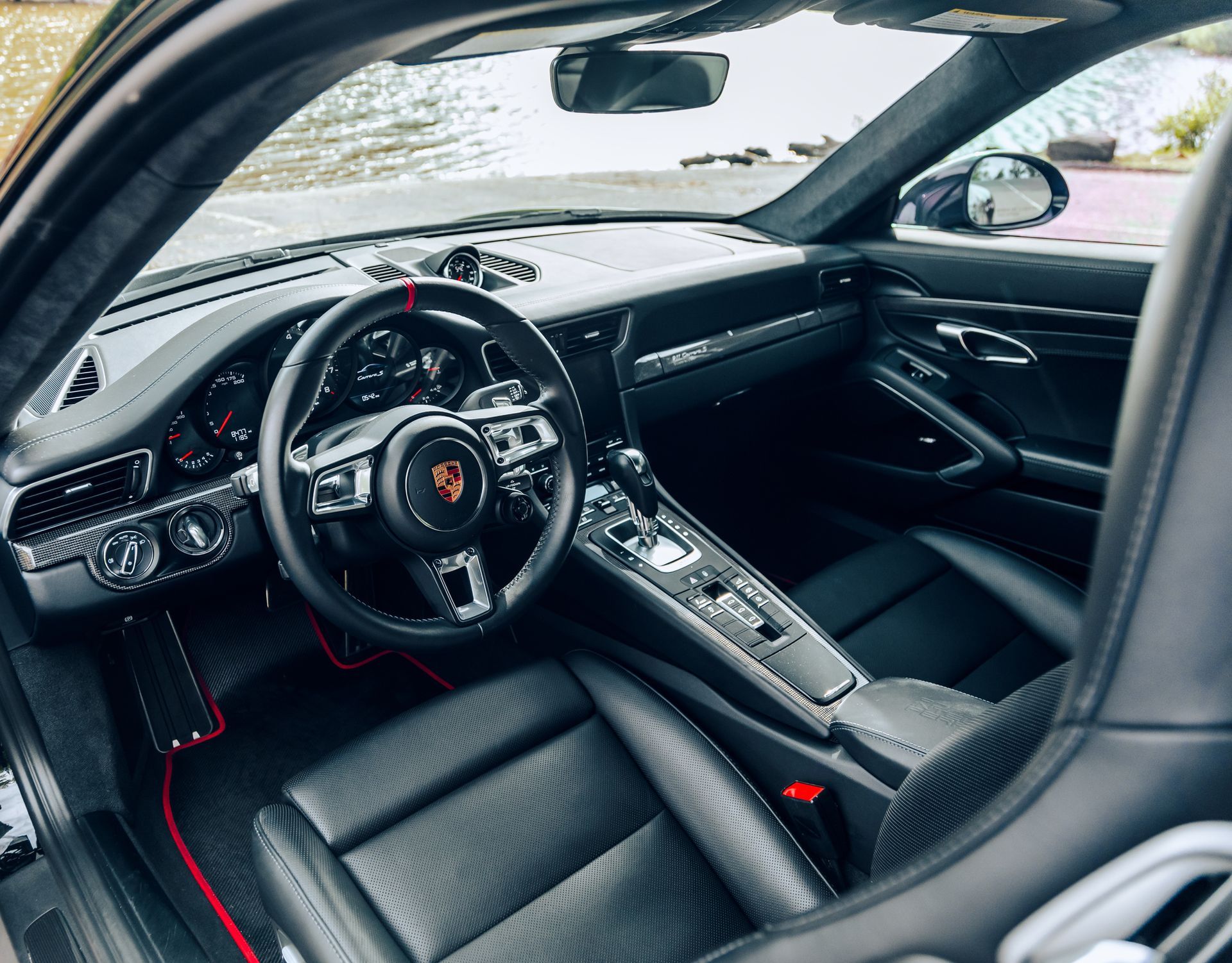 The interior of a porsche 911 is shown with the door open. | The Euro Shop