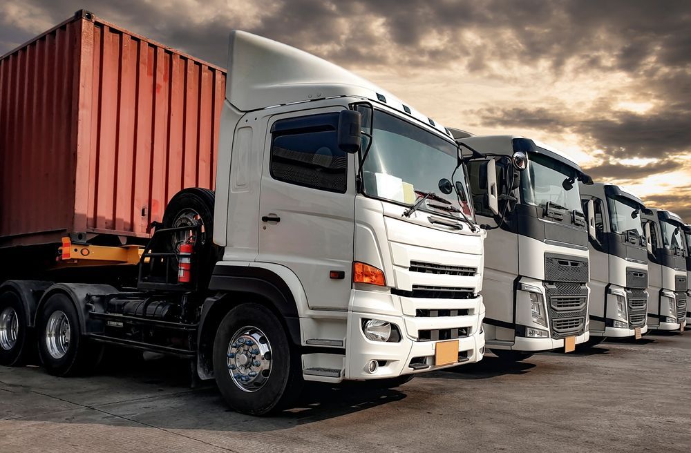 A Row Of Semi Trucks Parked Next To Each Other In A Parking Lot — R2B Heavy Vehicle Driving School In Moranbah, QLD