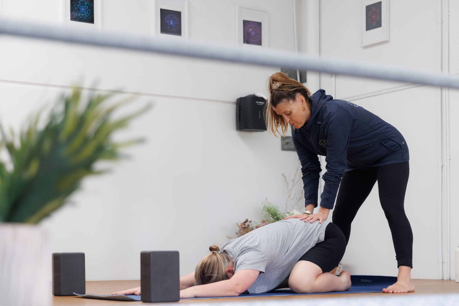 Rebecca working a yoga routine with a customer.