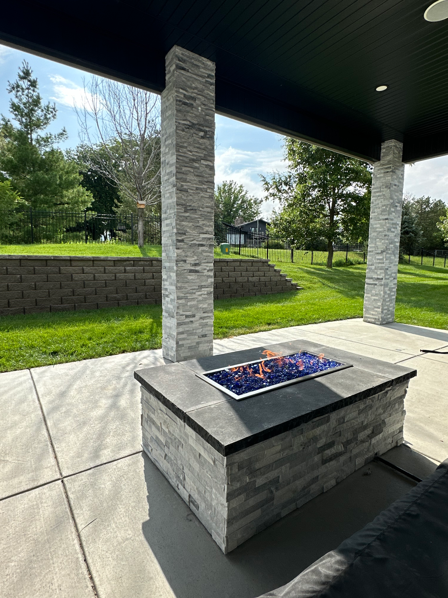 There is a fire pit in the middle of the patio.