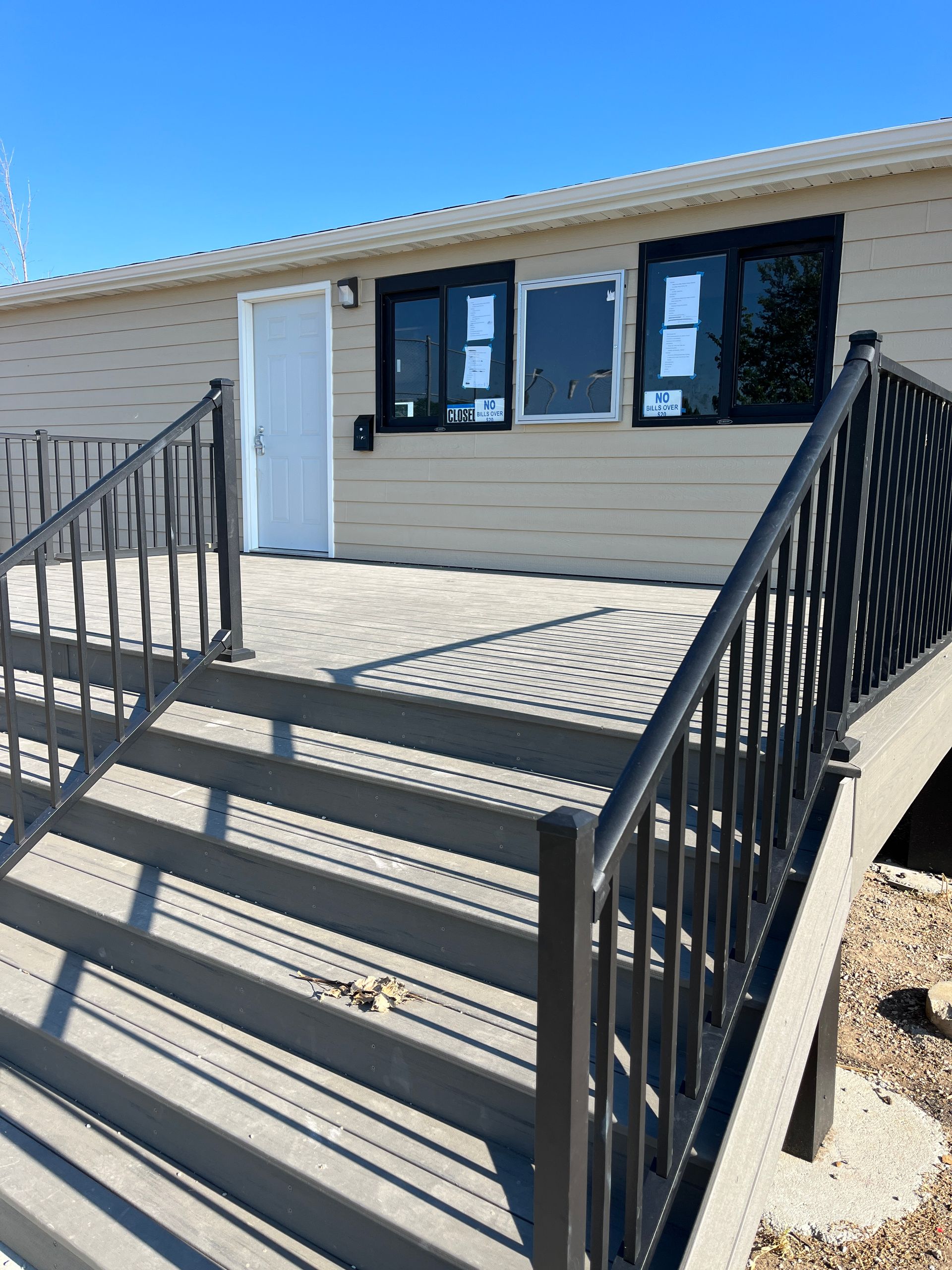 A house with stairs leading up to it and a railing.