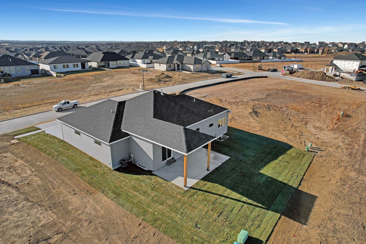 An aerial view of a house in a residential area.