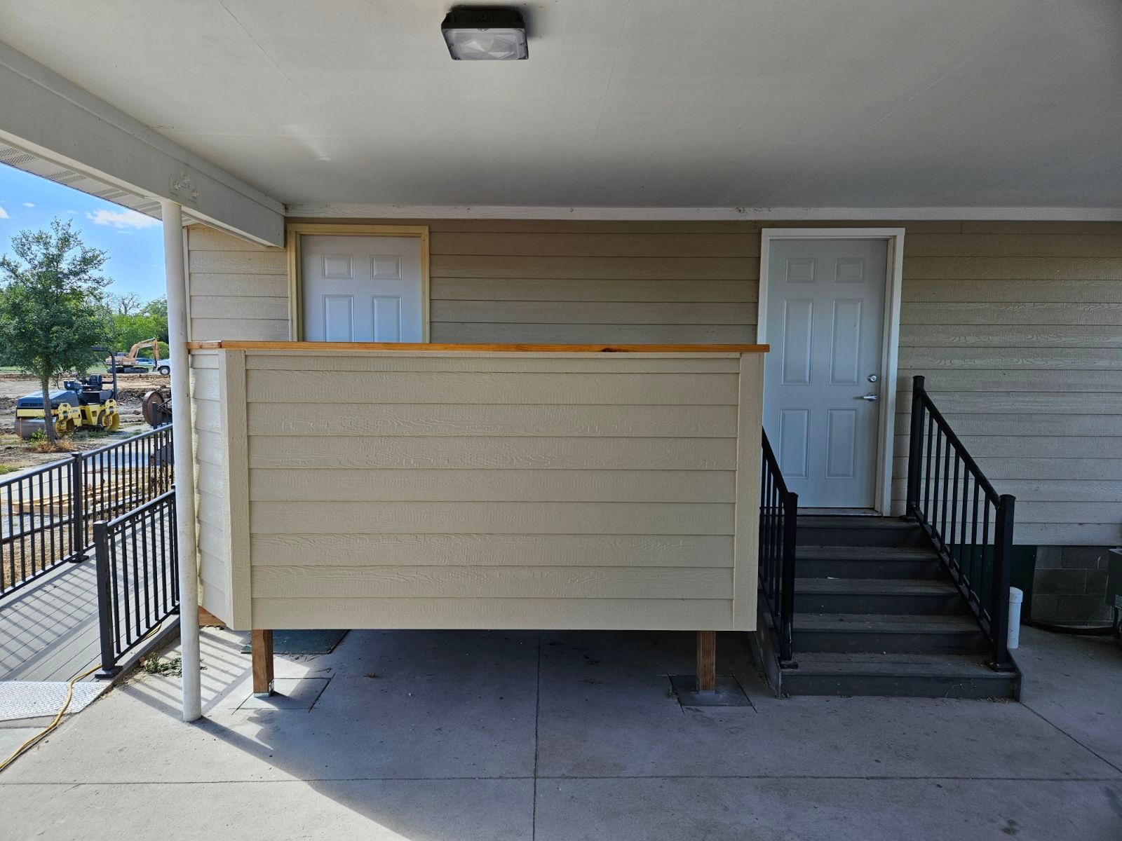 A house with a porch and stairs leading up to it.