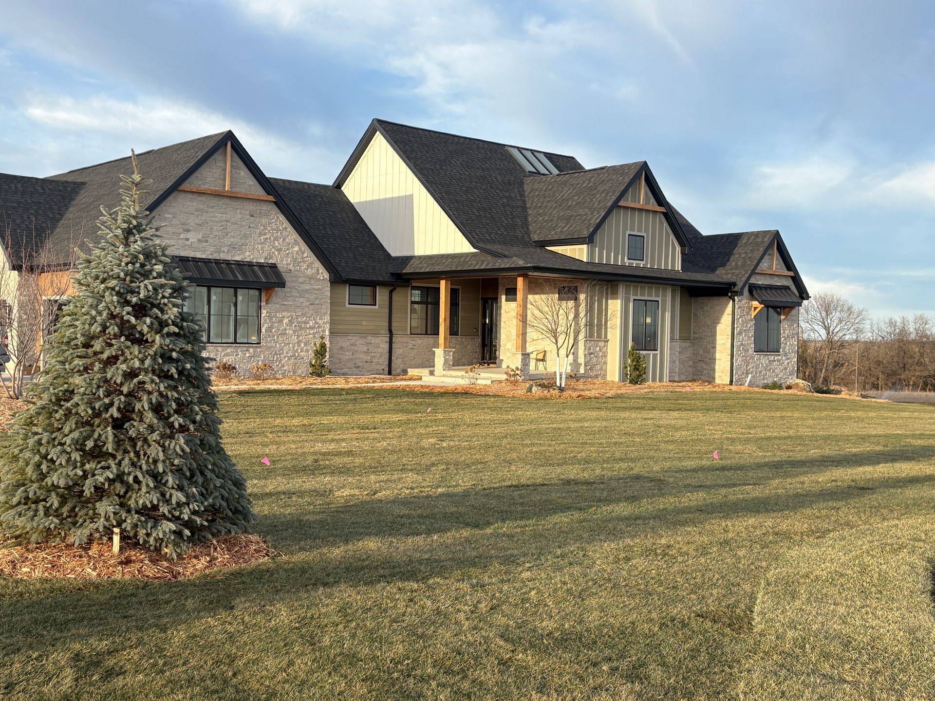A large house with a Christmas tree in front of it.