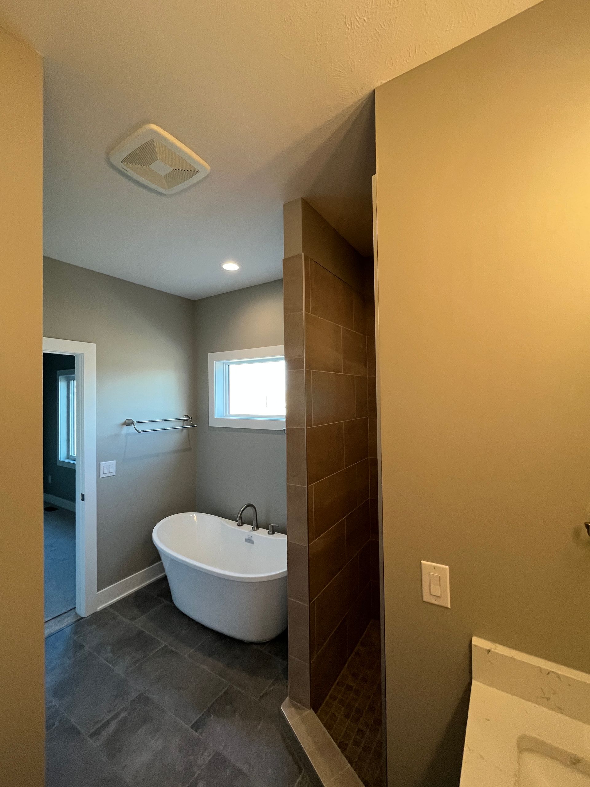 A bathroom with a bathtub and a walk in shower.