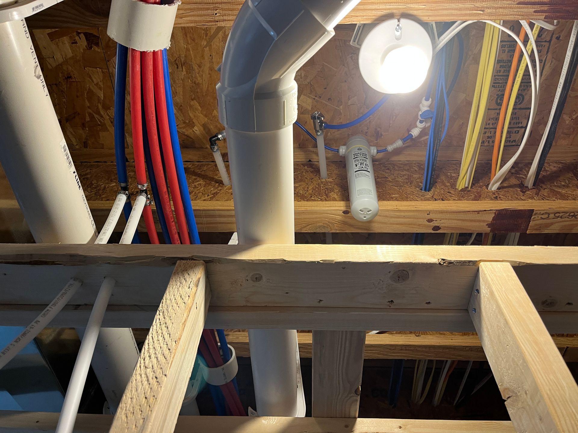 A bunch of wires are hanging from the ceiling of a building.