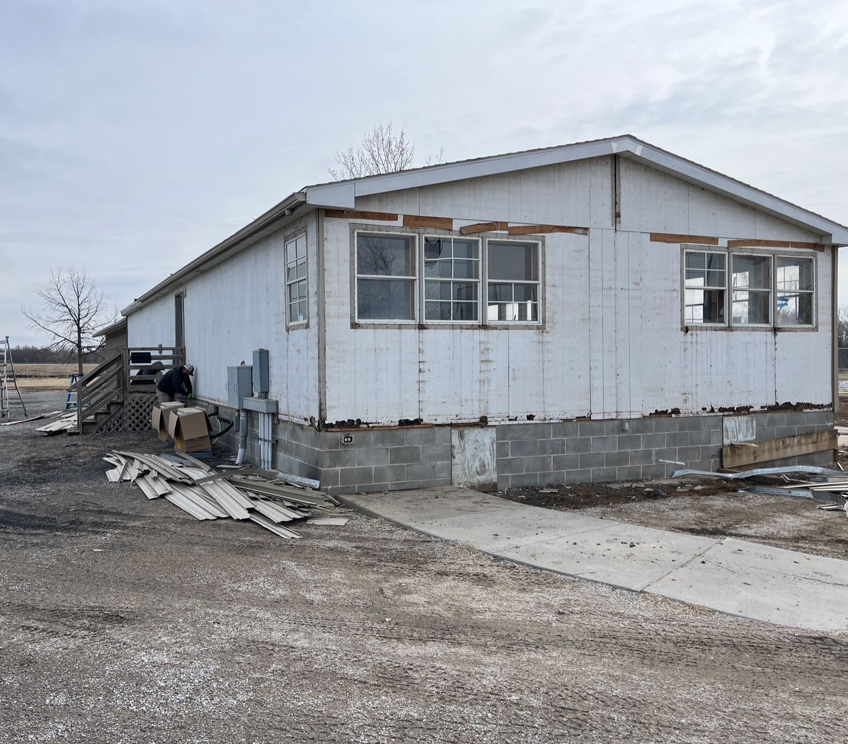 A white mobile home with a lot of windows