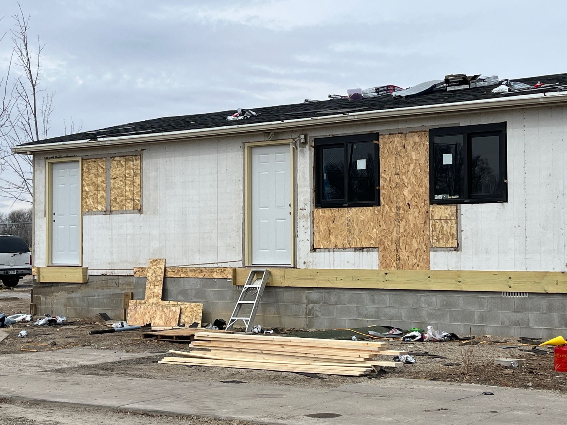 A house that is being built with a ladder in front of it.