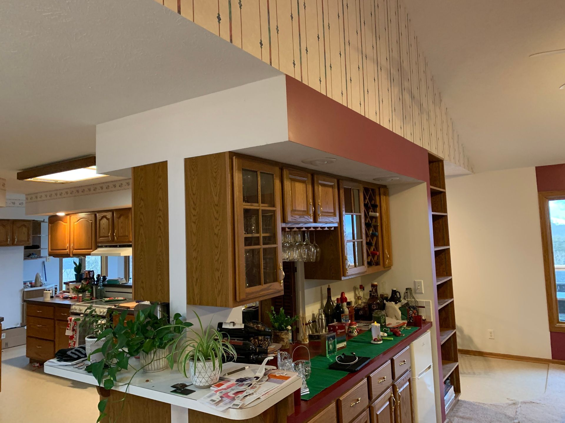 A kitchen with wooden cabinets and a green counter top