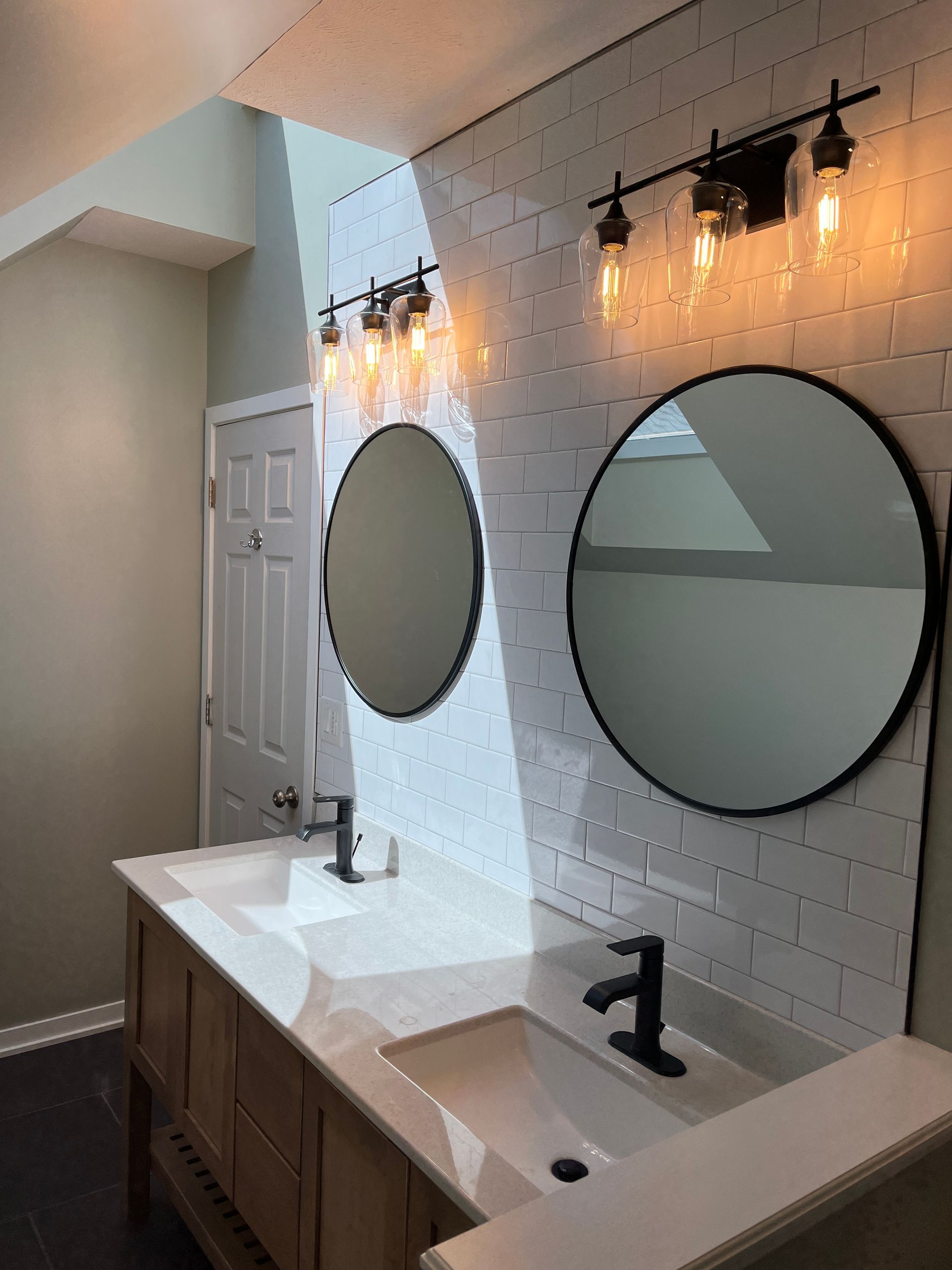 A bathroom with two sinks and two mirrors.