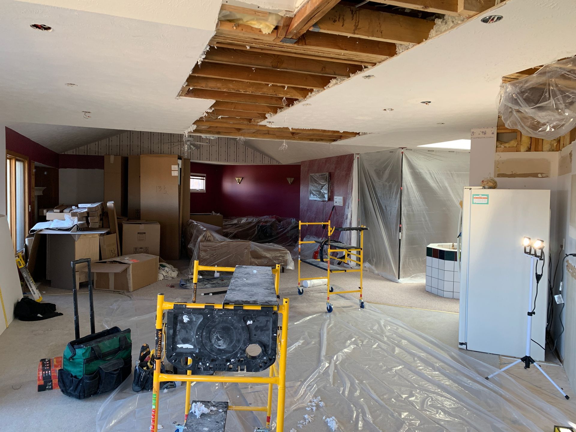 A large room with a ceiling that is being remodeled.
