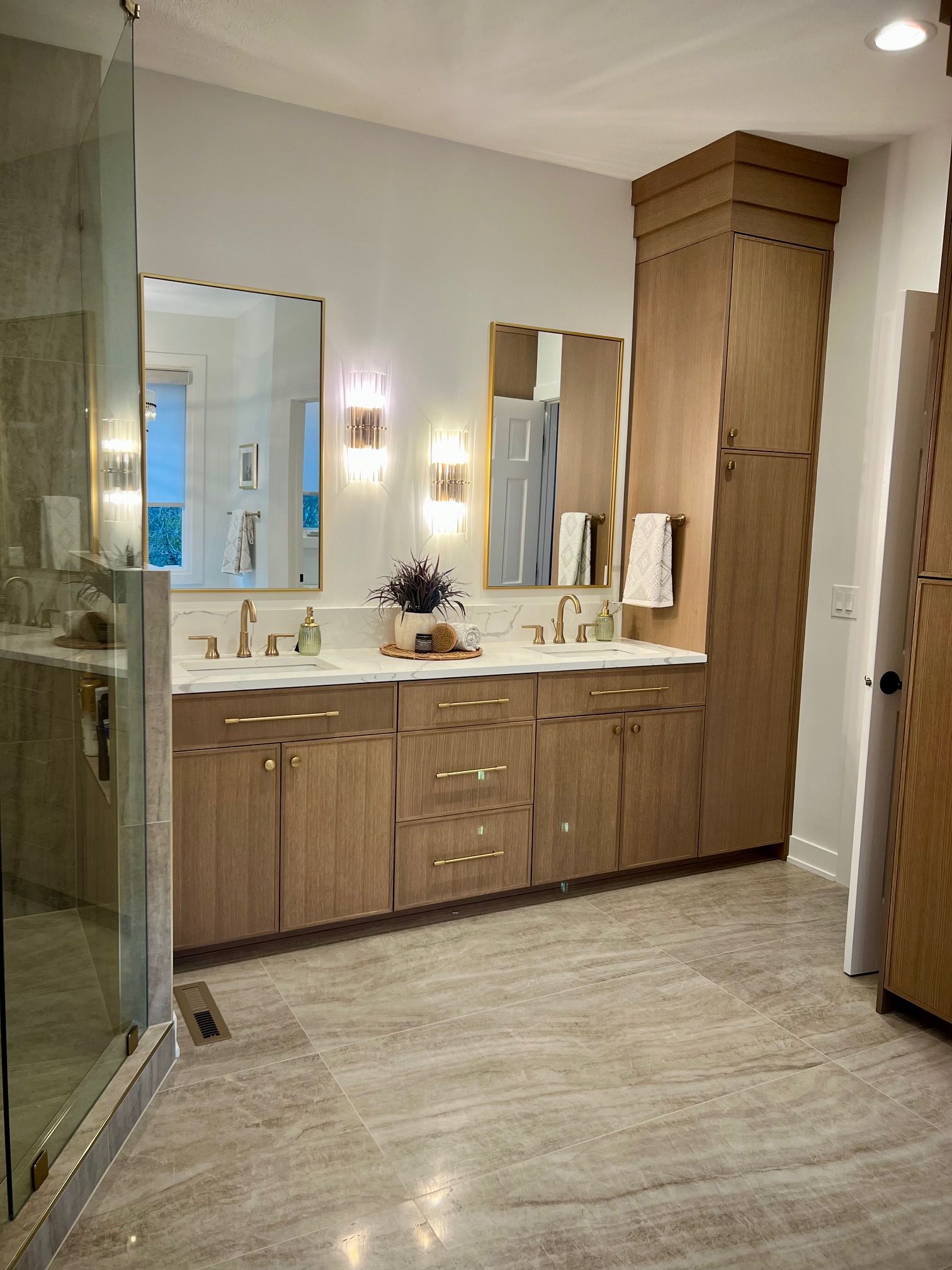 A bathroom with a toilet , sink , mirror and shower.