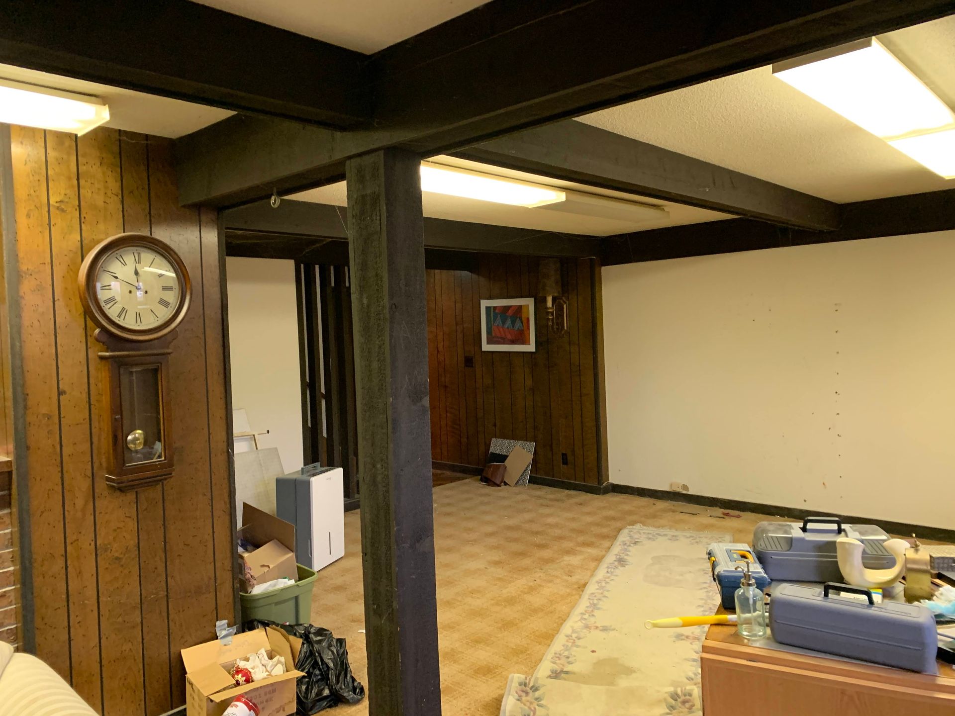 There is a clock on the wall in the middle of the room.