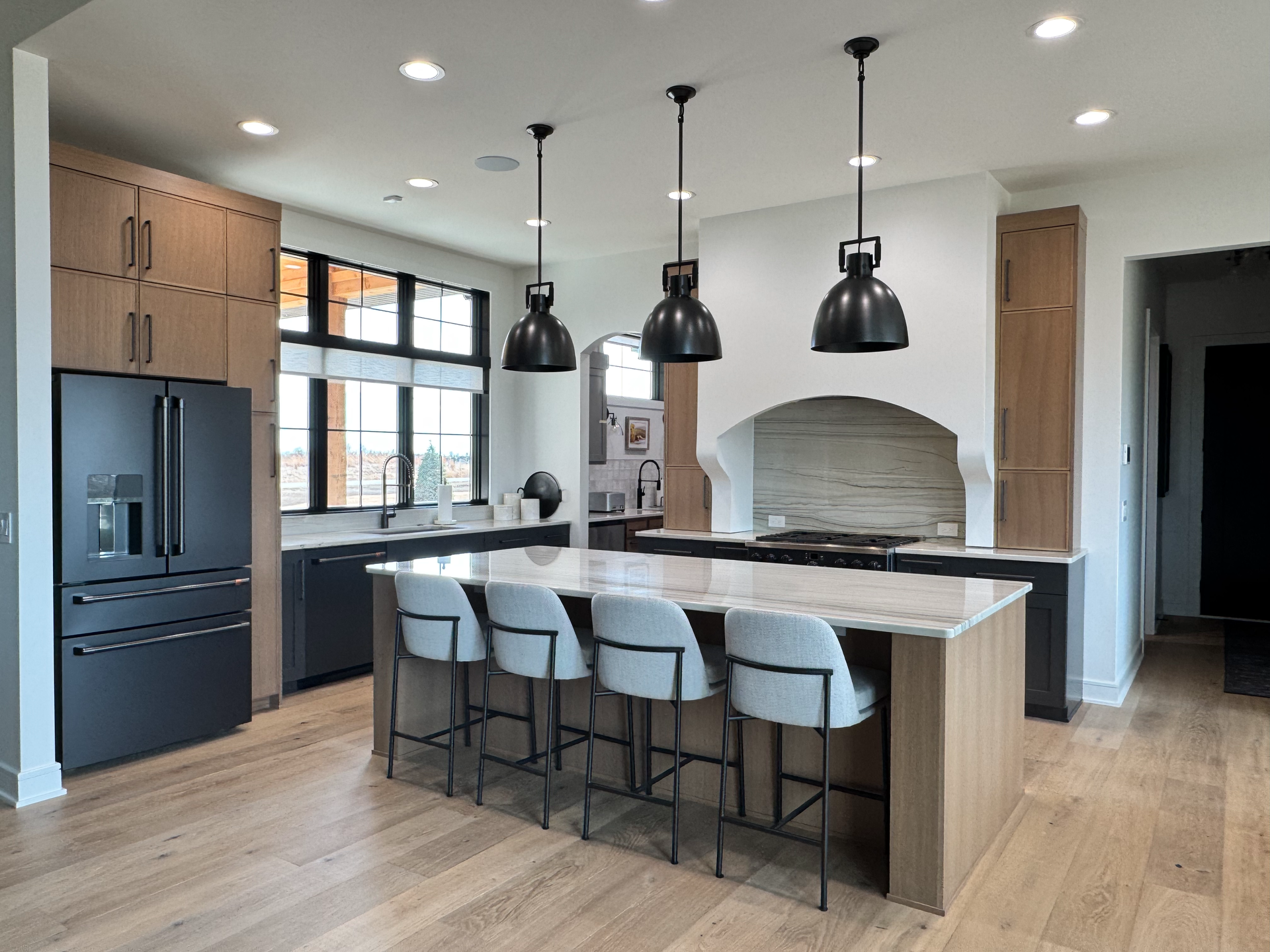 A large kitchen with a large island and stools.