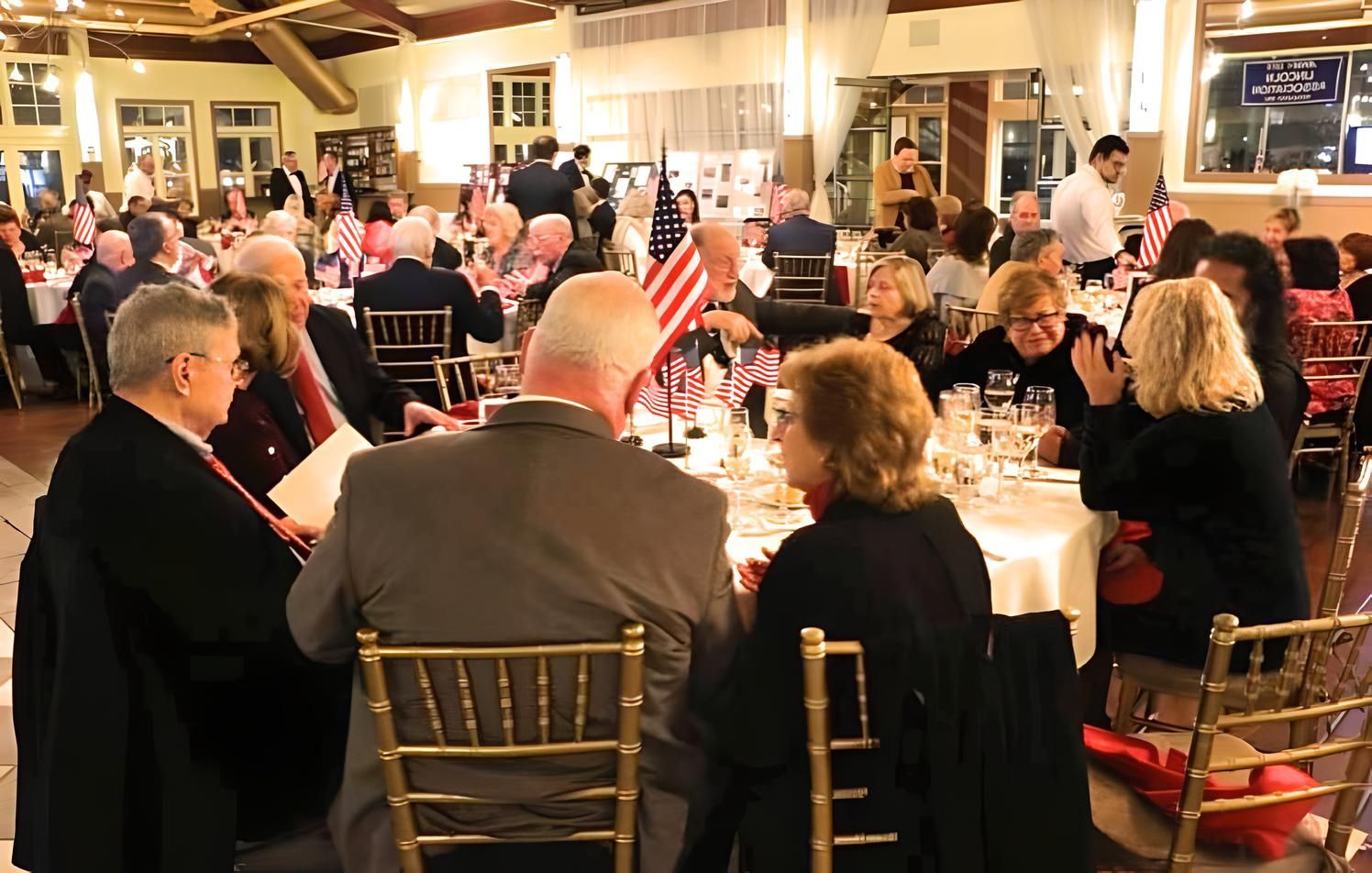 members of the lincoln association of jersey city sitting at tables having dinner during the annual dinner event