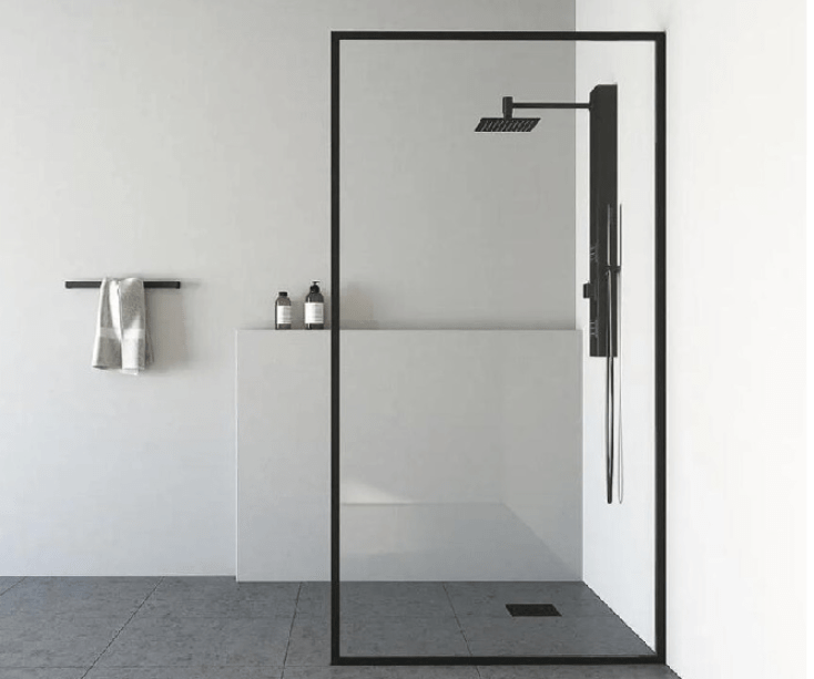 A tiled walk-in shower with a glass door, pebble floor, white subway tile walls, and a towel rack on the exterior wall.