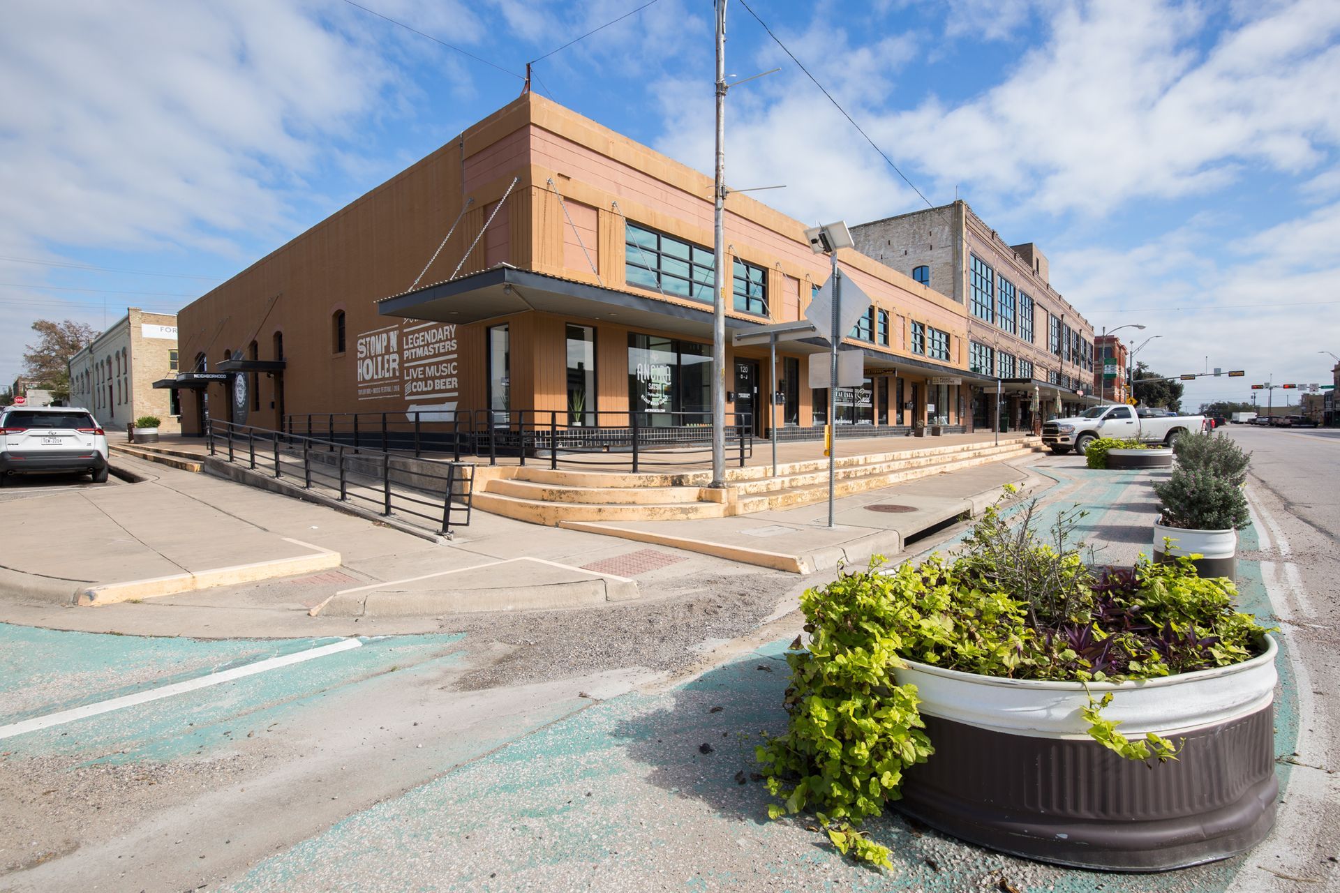 a large building is sitting on the corner of a city street .