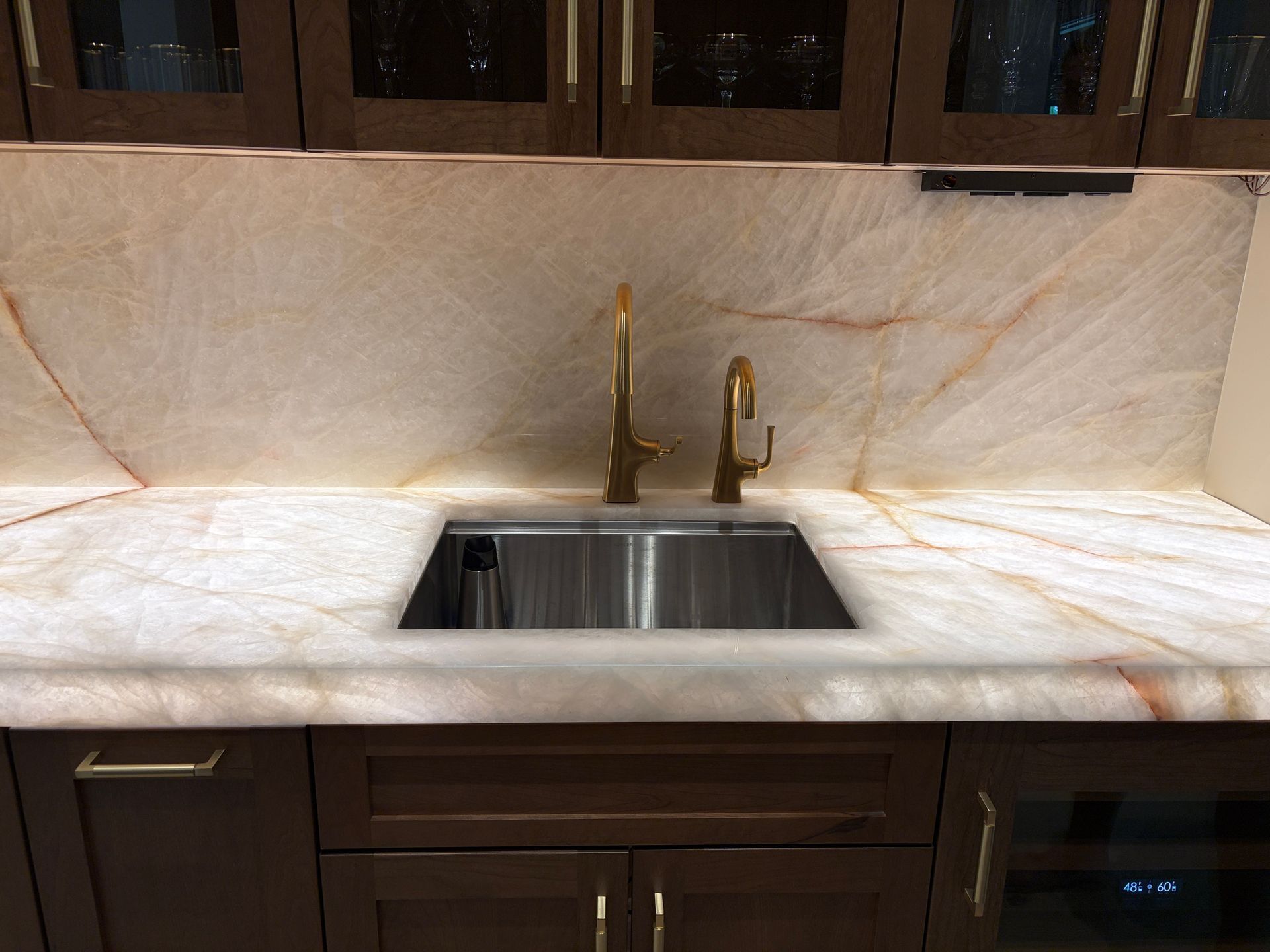 Backlit quartzite countertop and slab backsplash at a home bar in Davie FL