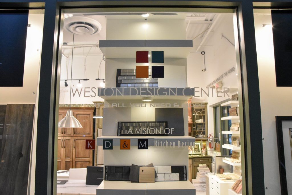 Storefront window with “Weston” signage and shelves of neatly arranged items inside