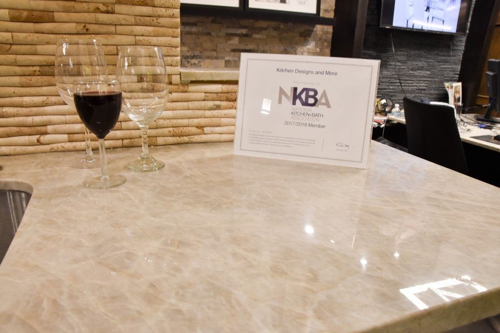Wine glass and menu card on a marble restaurant table with stone wall backdrop