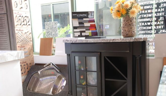 Modern dining area with dark cabinet, glassware, and yellow flowers near a window