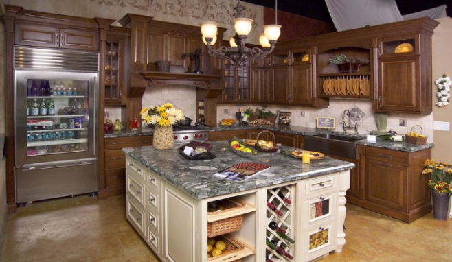 Luxury kitchen with dark wood cabinets, granite island, and stainless steel fridge under pendant lights