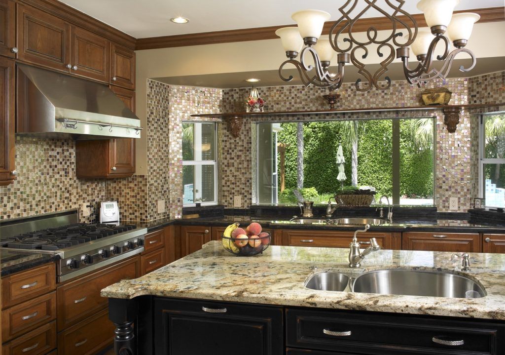 Luxury kitchen with wood cabinets, granite island, stainless appliances, and large window over the sink