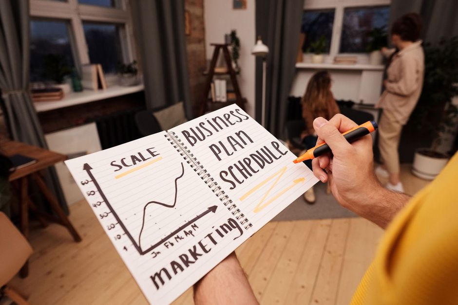 Person outlining a business growth and marketing plan
