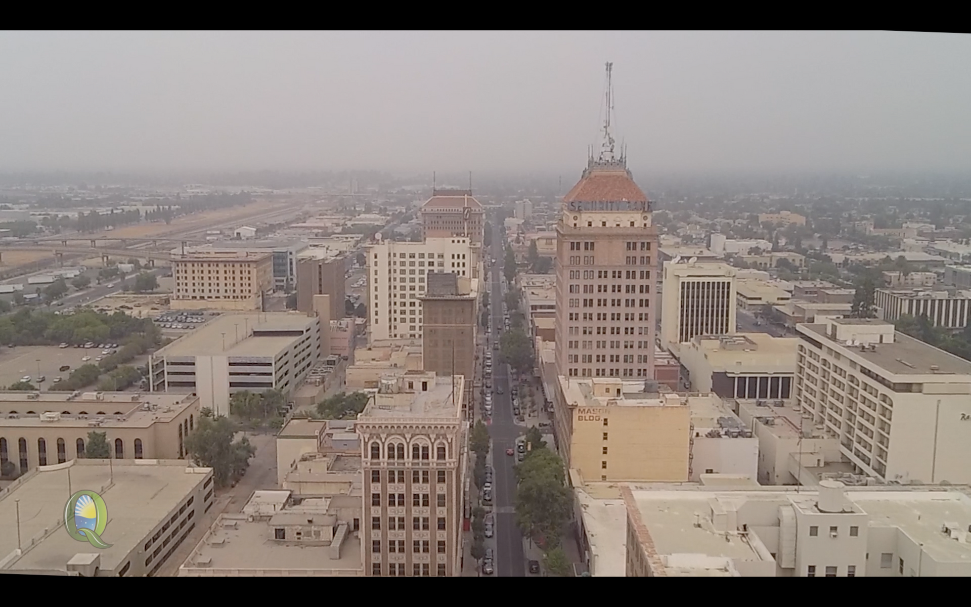 Aerial view of downtown Fresno, California with tall buildings along a wide street.