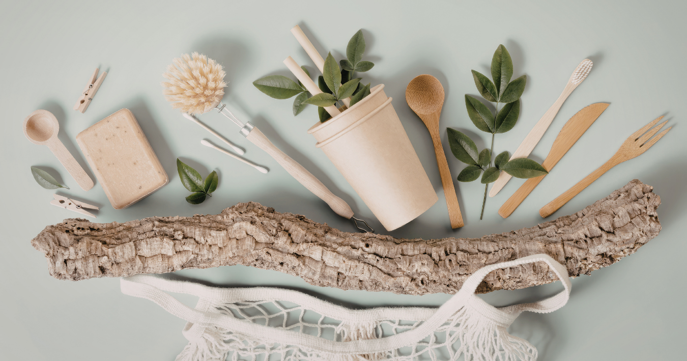 Flat lay of natural bath products with candles, wooden brush, eucalyptus, and soap on a light background