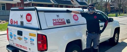 A man is standing next to a white truck.